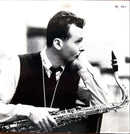 a black and white photo of a man playing a saxophone