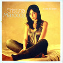 a woman sitting on a bed with her legs crossed