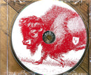 a red and white picture of a bison on a wooden surface