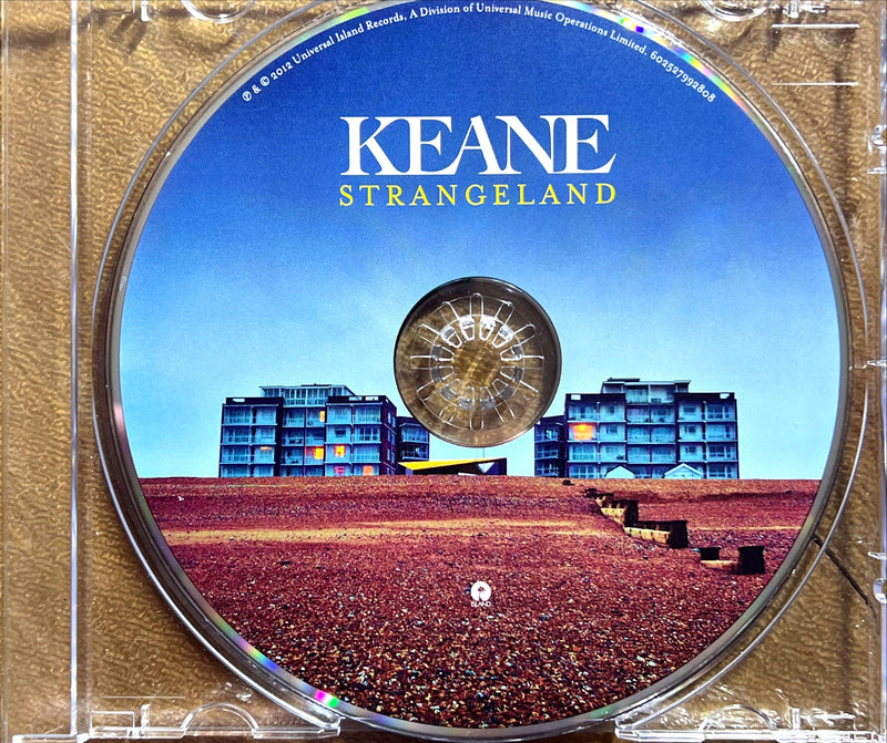 a cd with a picture of a building in the background