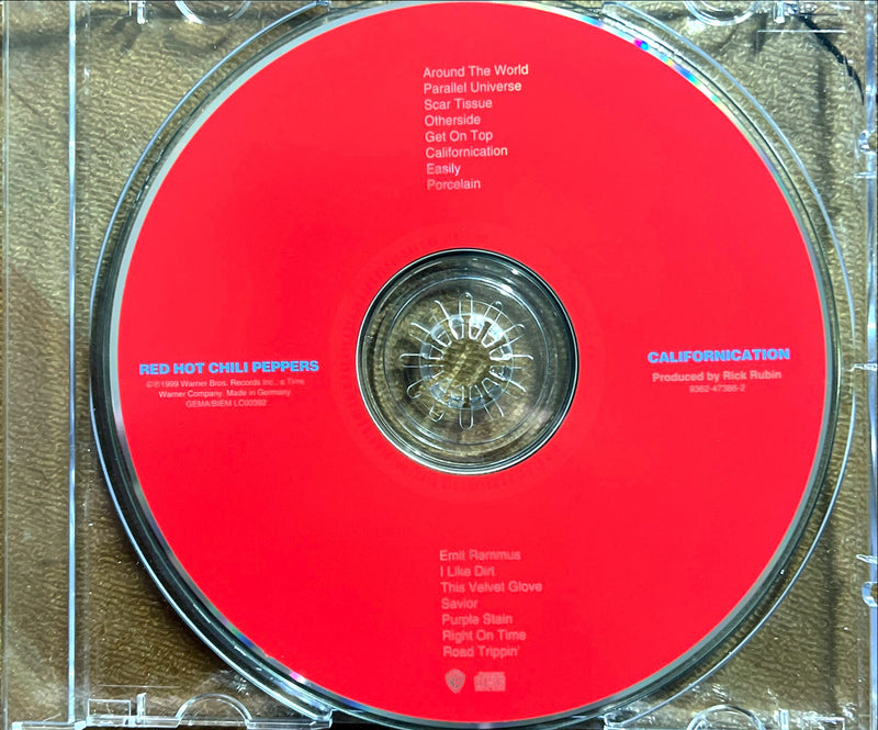 a red cd case with a clock inside of it