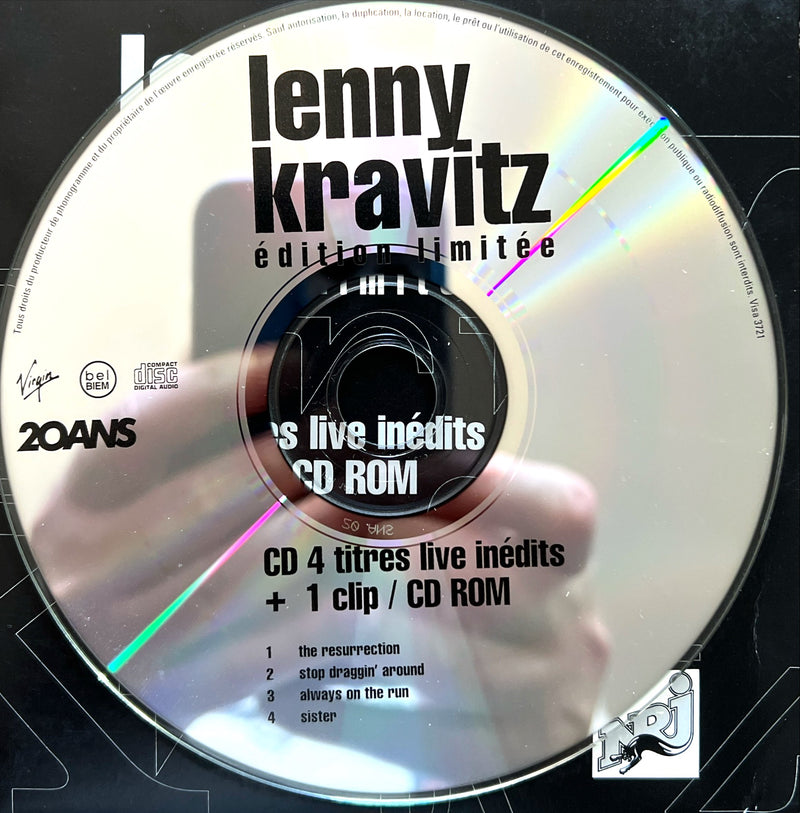 a cd with a person holding a cell phone