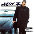 a man standing next to a car in front of a white wall