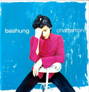 a person sitting on a chair in front of a blue wall