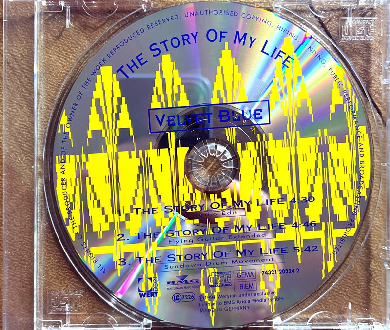 a cd in a clear case with a yellow and blue pattern