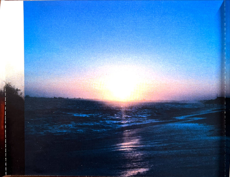 a picture of the sun setting over the ocean