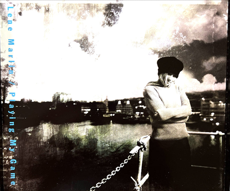 a woman standing on top of a pier next to a body of water