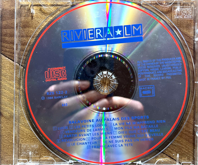 a cd with a person's hand on it