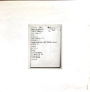 a black and white photo of a cat sitting on a table