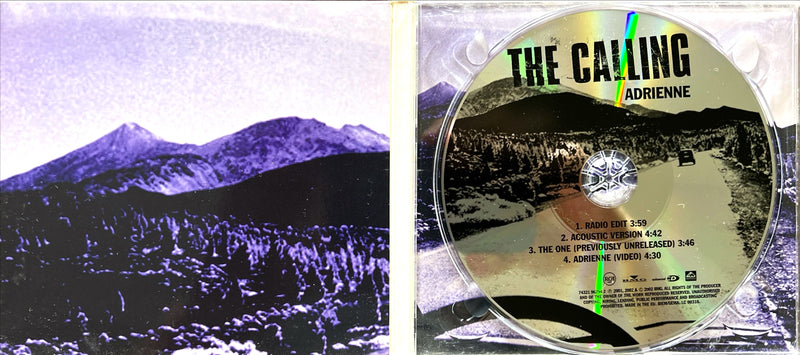 a cd with a picture of a mountain in the background