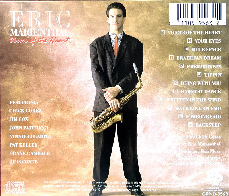 a man in a suit and tie holding a saxophone