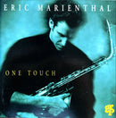 a man holding a saxophone in his right hand