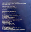 a close up of a sign on a wooden surface