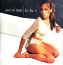 a woman sitting on top of a white bed