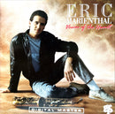 a man sitting on the ground with his foot on a skateboard