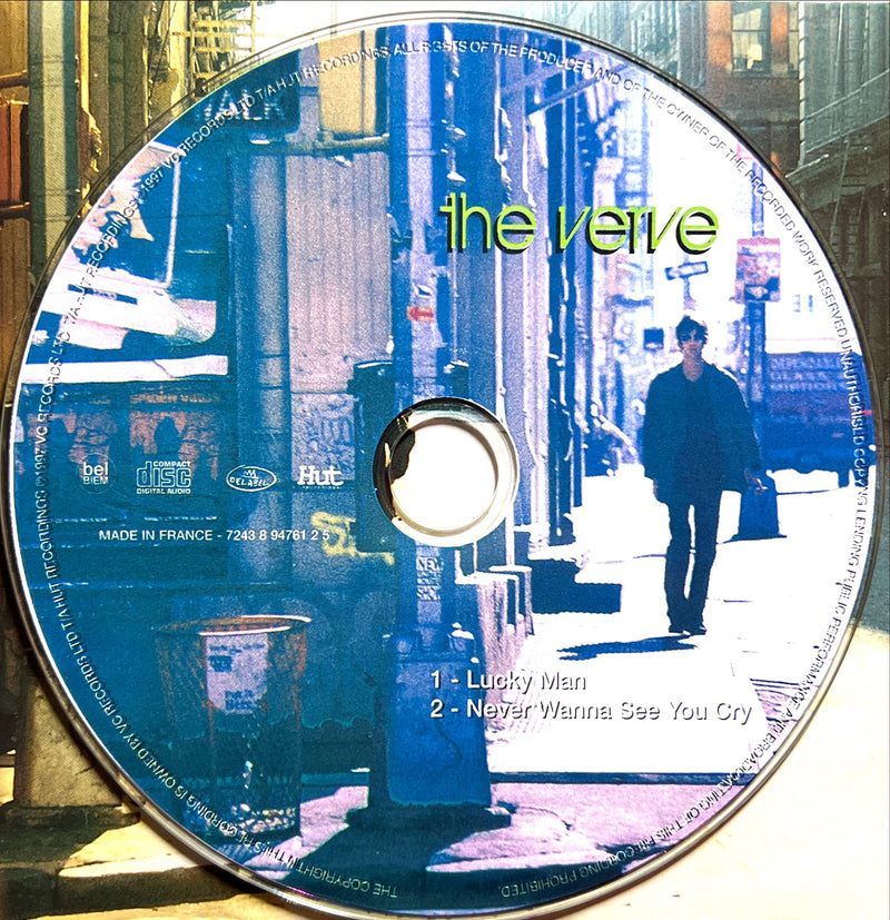 a cd with a picture of a man walking down the street