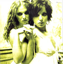 two beautiful young women standing next to each other