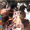 a woman standing in front of a rock formation