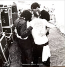 a black and white photo of a group of people hugging